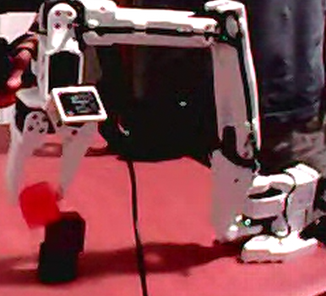red block slipping out of the robot arm's grip