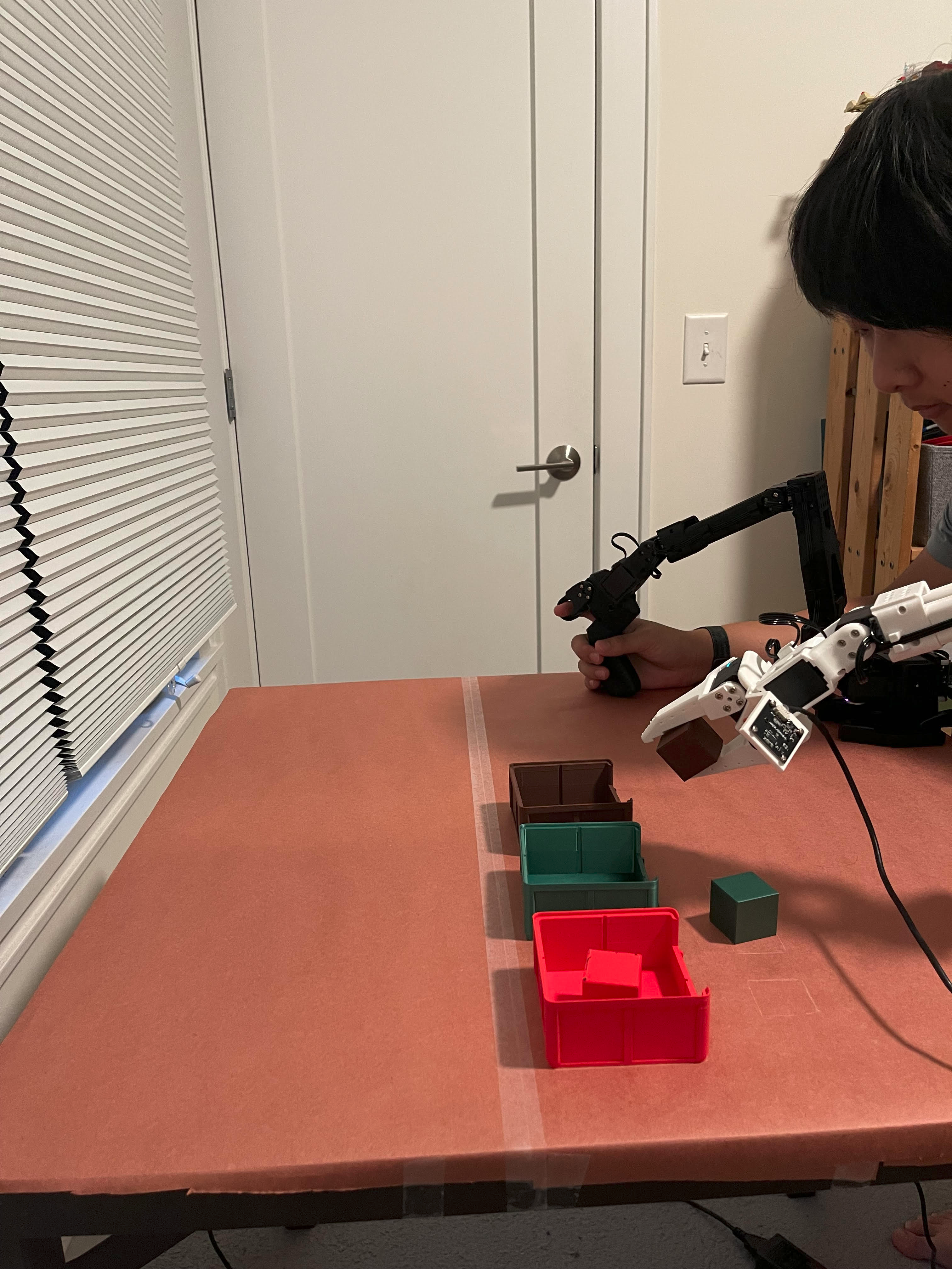 This really cool and handsome person is operating the SO-101 robot arm